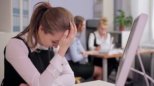 Stressed Woman at Computer in Office Workplace