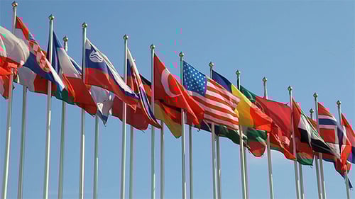 Flags of the World Waving Against Blue Sky