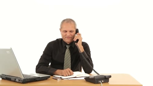 Adult Man Talking on Telephone at Desk