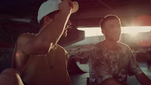 Stylish Hipsters Relaxing Skatepark at Sun Rays