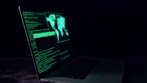 Hacker Concept. Code On A Laptop Computer Monitor In A Dark Room