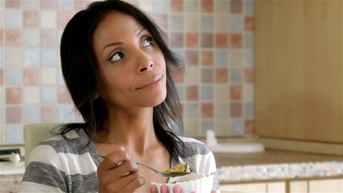 Woman Enjoys Healthy Breakfast Snack at Home