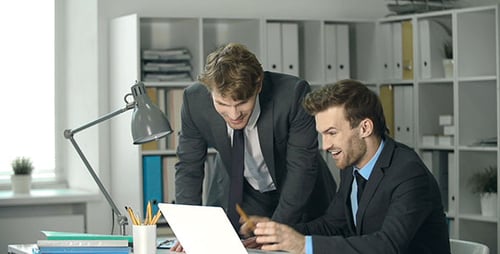 Excited Businessmen Celebrate Success in Bright Office