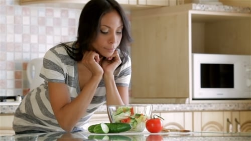 Woman Enjoys Healthy Salad in Bright Kitchen