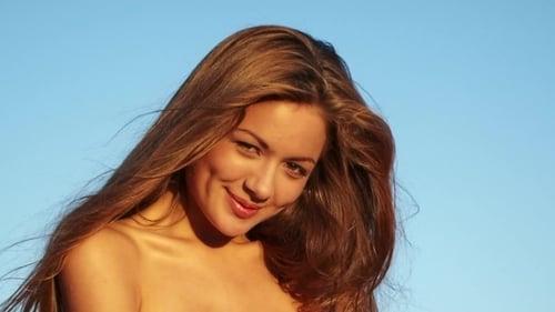 Beautiful Woman Smiling against Blue Sky