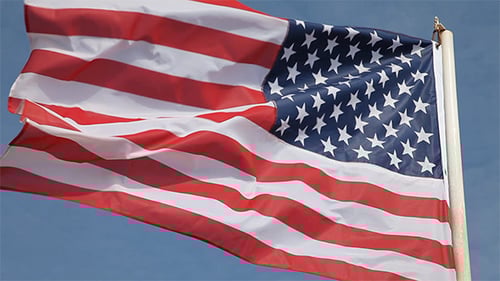 American Flag Waving Against Clear Blue Sky