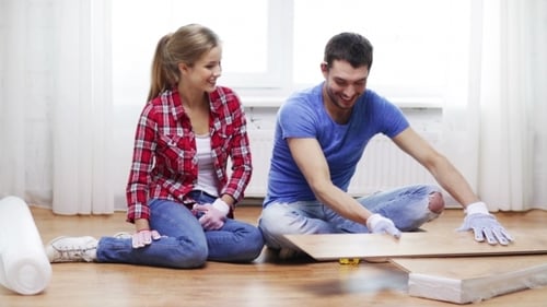 Couple Installing New Laminate Flooring at Home
