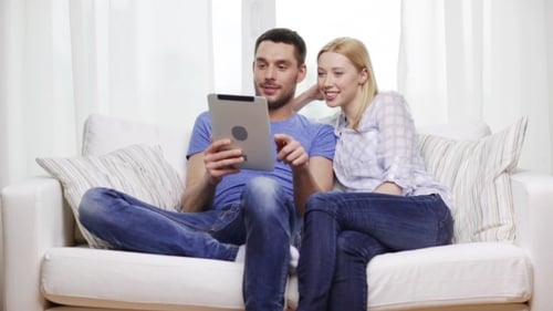 Happy Couple With Tablet Pc At Home