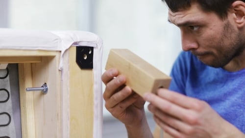 Attaching a Wooden Leg to a White Sofa
