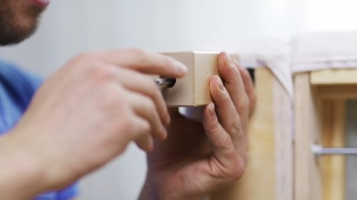 Man Assembling Leg To Sofa
