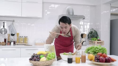 Man Preparing Fresh Salad in Modern Kitchen