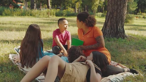 Kids Enjoying Story Time with Adult in Park