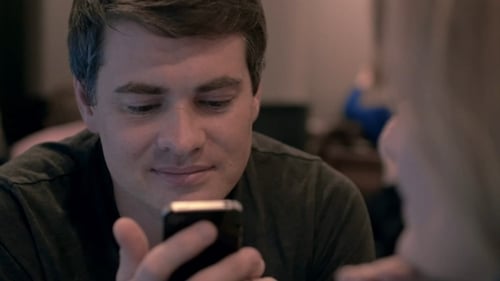 Young Man Using Cell Phone With Happy Look