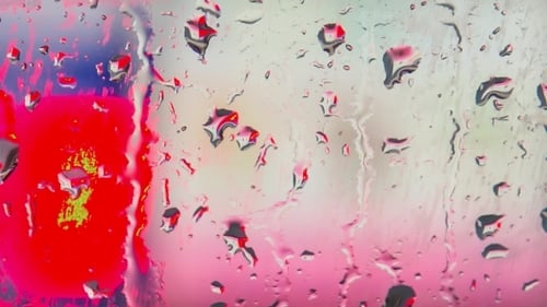Raindrops Slowly Moving Down On Window
