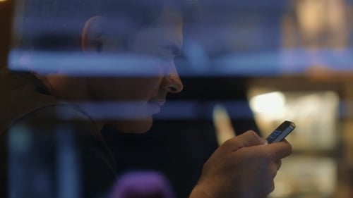 Man Using Phone To Browse Social Network Service