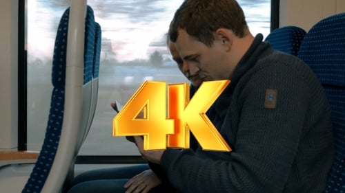 Couple Using Tablet on Moving Passenger Train