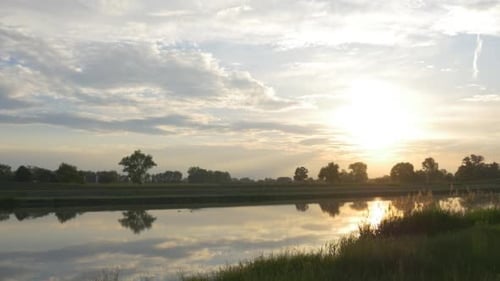 Spiegelung des gelben Sonnenuntergangs in glattem Wasser,