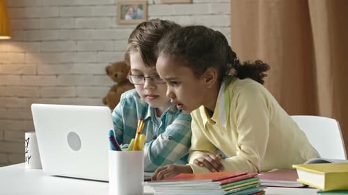 Children Use Laptop for Homework Indoors