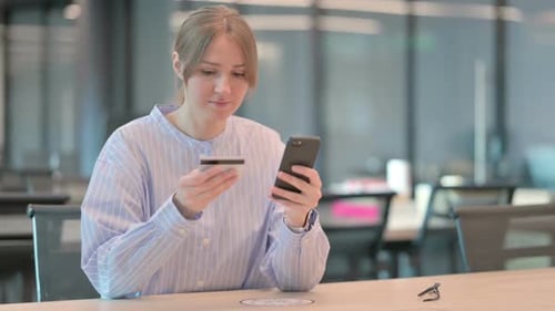 Woman Shops Online with Smartphone and Credit Card