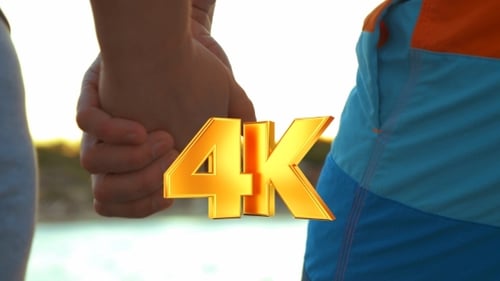 Couple Holding Hands by the Beach at Sunset