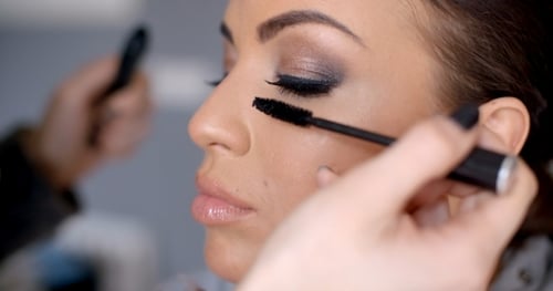 Applying Mascara to a Beautiful Woman's Eyelashes