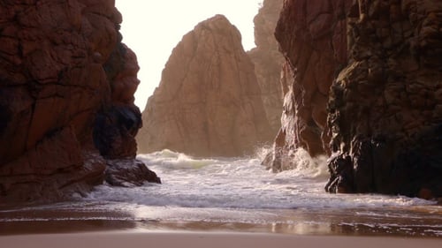 Rocks and Surf Backlit Sun