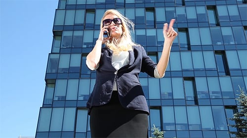 Businesswoman Talking on Phone Outside Modern Building