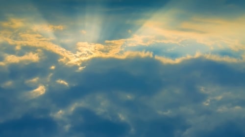 Bright Sunbeams Through Moving Clouds