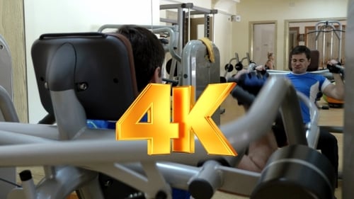 Man Having Workout On Modern Exercise Machine
