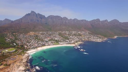 Aerial travel drone view of Camps Bay beach, Cape Town, South Africa.