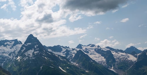 Majestic Mountains with Snow and Clouds