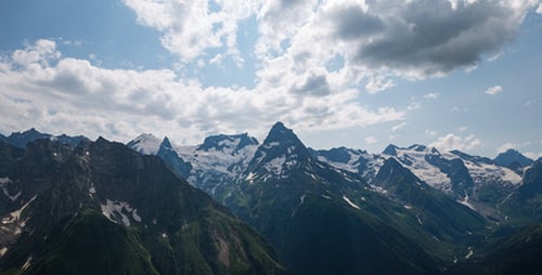Dramatic Mountain Range Under Cloudy Skies