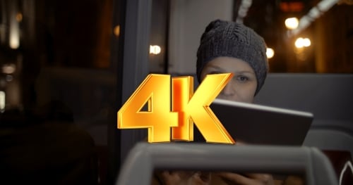 Woman Uses Tablet on Bus at Night