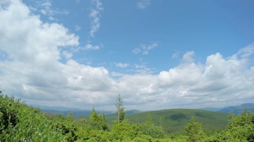 Green Mountain Landscape with Clouds and Blue Sky