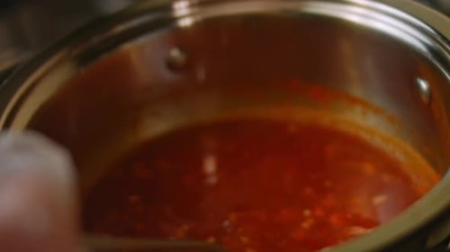 Cooking Tasty Red Sauce in Stainless Steel Pot