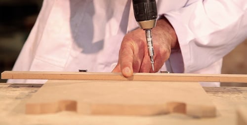 Hands Attach Wood Pieces with Drill