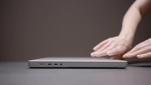 The Hand Opens the Laptop