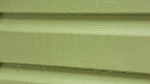 Drops Of Water Flowing Down On Green Wall