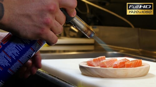 Chef Cooking Salmon with Blow Torch