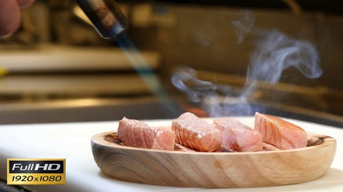 Cooking Salmon with Blowtorch Close Up in Kitchen