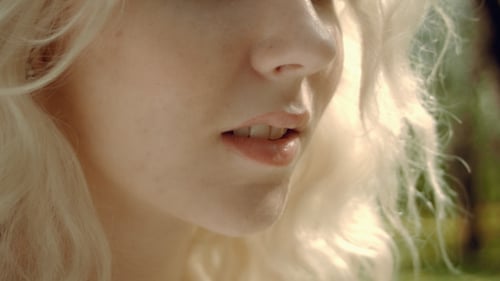 Blonde Haired Woman Speaking Outdoors in Close Up
