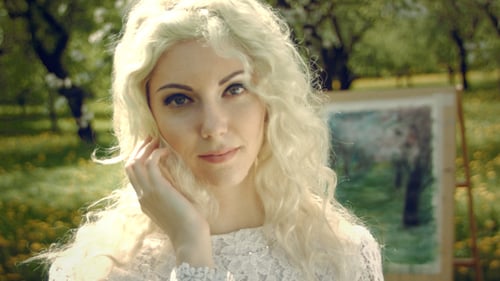 Beautiful Woman Posing in a Spring Orchard