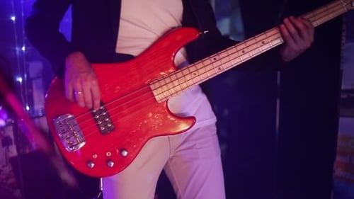 Musician Playing Red Electric Bass Guitar