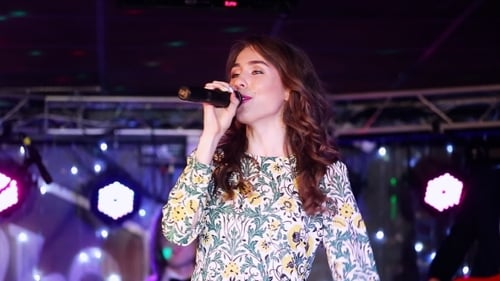 Female Singer Performing Live on Stage at Night