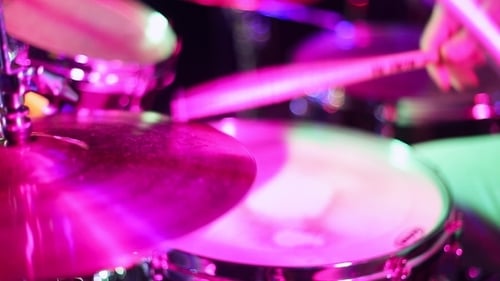 Drum Kit Being Played with Colorful Lighting
