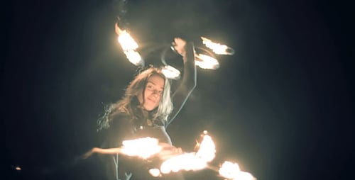 Woman Performing with Fire at Night