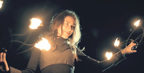 Woman Performing Fire Spinning at Night