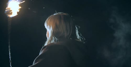 Young Woman Spinning Fire at Night