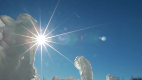 Icy Sculptures Gleam Under Sunny Blue Sky