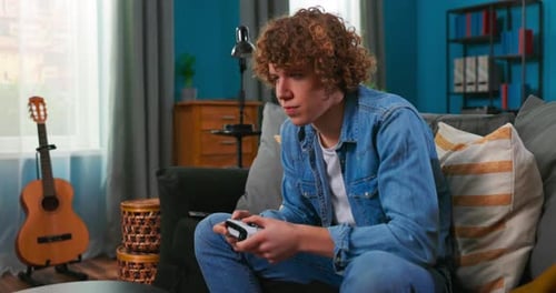 Young Adult Playing Video Games at Home